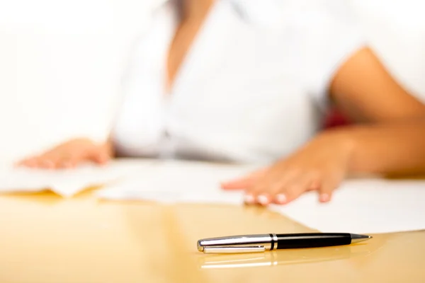 stock image Pencil on a desk with secretary behind