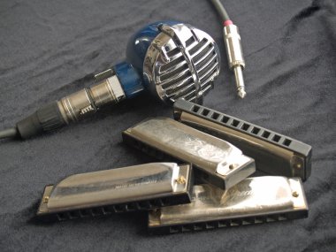 Blues harmonicas and a vintage microphone clipart