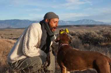 Man playing with his dog clipart