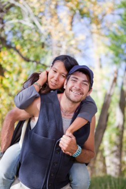 Young couple in fall forest clipart