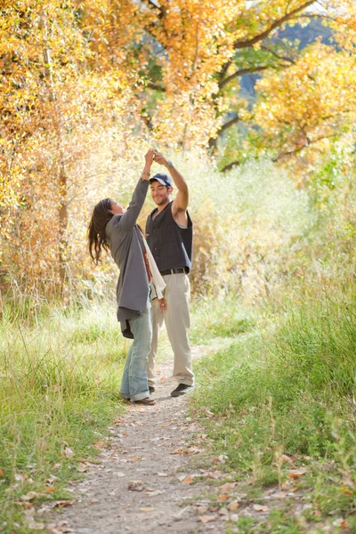 Young couple dancing in fall forest — Stock Photo, Image