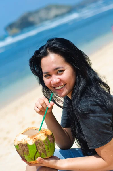 stock image Beautiful woman drinking coconut water