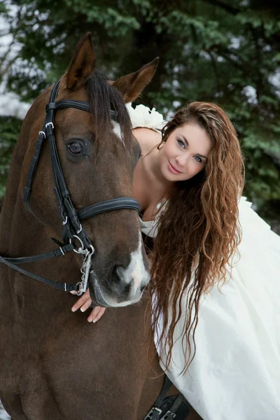 Girl in a white dress on a horse — Stock Photo, Image