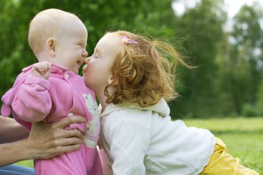 Happy girls sister in the park clipart