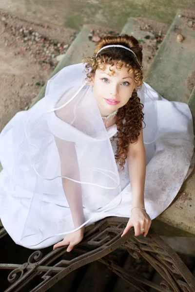 Kudrnaté nevěsta na pozadí kamene zříceniny — Stock fotografie