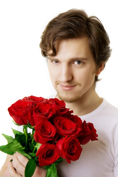 Hermoso hombre con un ramo de rosas — Foto de Stock