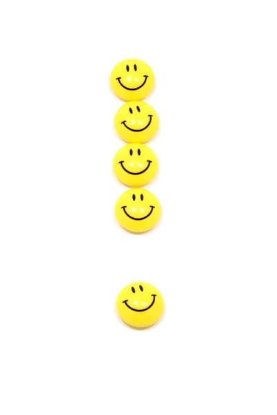 Ponto de exclamação em smileys amarelos — Fotografia de Stock