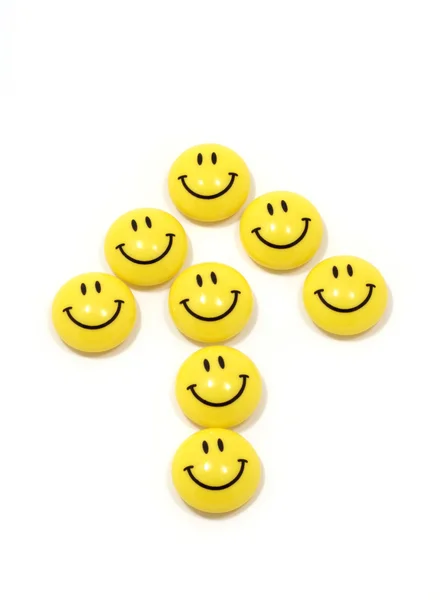 Symbole de la flèche faite de sourires jaunes — Photo