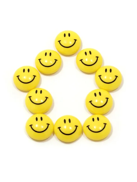 Symbool van een huis gemaakt van gele smileys — Stockfoto