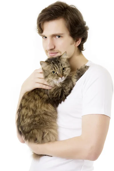 Человек, который держит под рукой пушистую кошку — стоковое фото