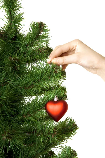 Hand hangs on New Year's pine decoration heart — Stock Photo, Image
