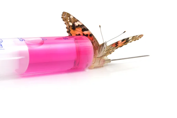 Butterfly is sitting on a syringe — Stock Photo, Image