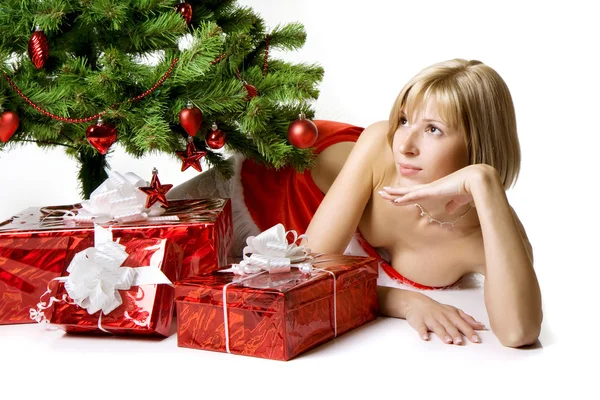Santa girl lying under the tree — Stock Photo, Image