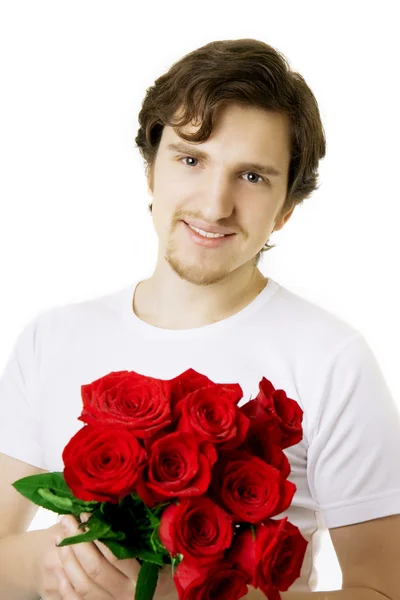 Hermoso hombre con un ramo de rosas Imagen de archivo
