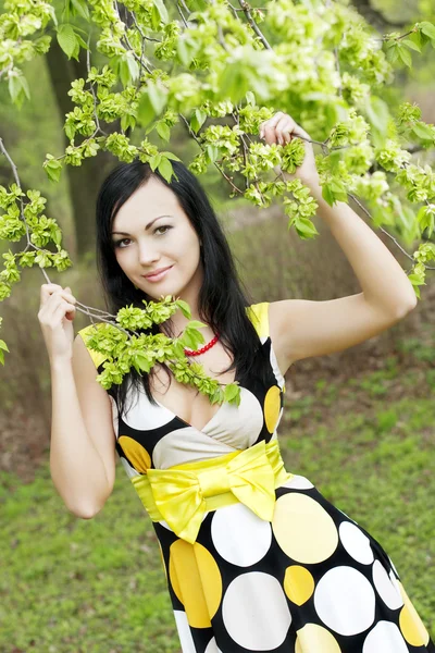 Girl and blossoming spring plants — Stock Photo, Image