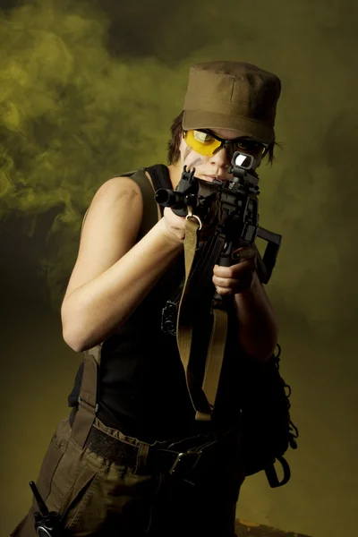 Stock image Girl soldiers in the smoke