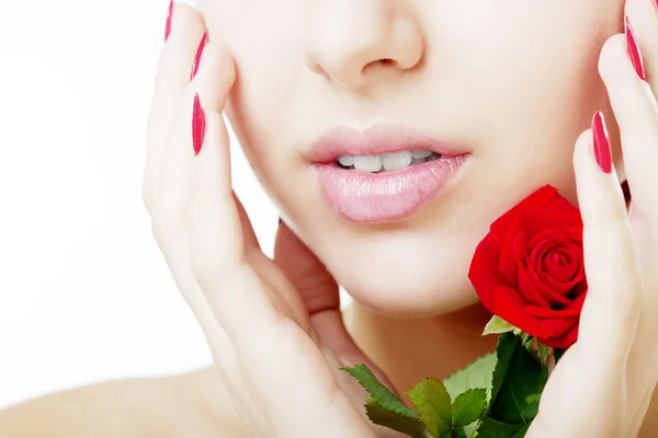 Mooi meisje gezicht close-up met een roos in de hand — Stockfoto