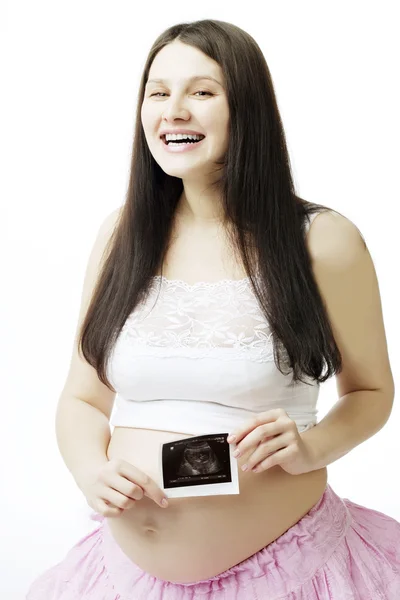 Gravid kvinna med ett fotografi av ultraljud. Royaltyfria Stockbilder