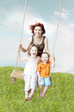Family swing against the sky and grass clipart