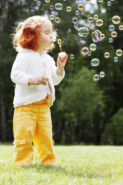 Meisje zet de bubbels in het park — Stockfoto
