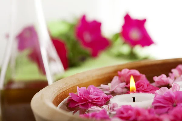 Wellnesstherapie, Blumen im Wasser, auf einer Bambusmatte. — Stockfoto