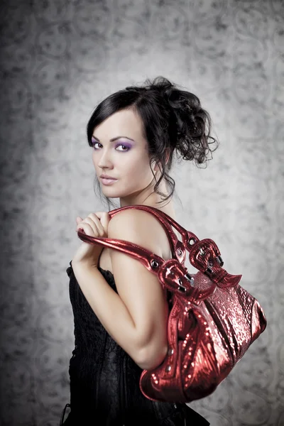 Luxus-Frau mit Tasche Stockbild