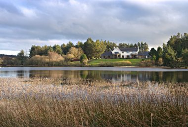 Modern House by the Lake in UK. clipart