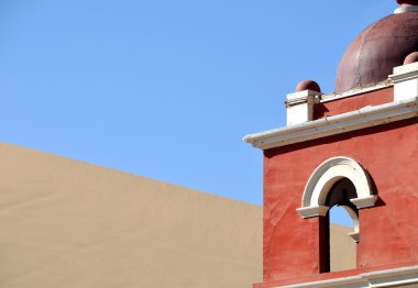 Top of a red church tower in desert clipart