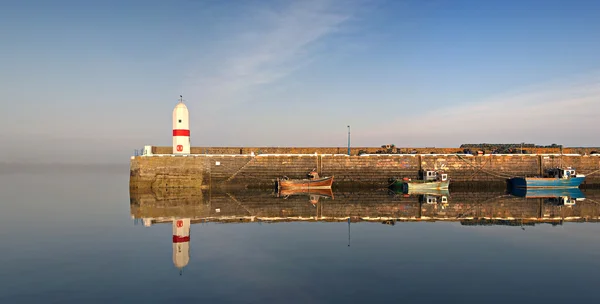 Rustige haven, vuurtoren en boten met water reflectie — Stockfoto