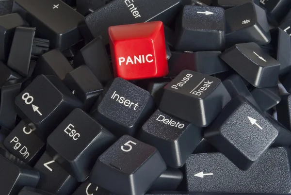 Stack of black computer keyboard keys with red panic button — Stock Photo, Image