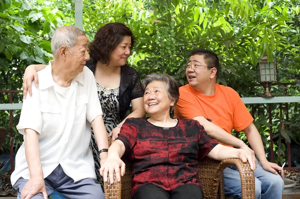 A happy family : an old couple and their children — Stock Photo, Image
