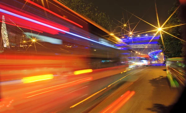 High-speed vehicles blurred trails on urban roads — Stock Photo, Image