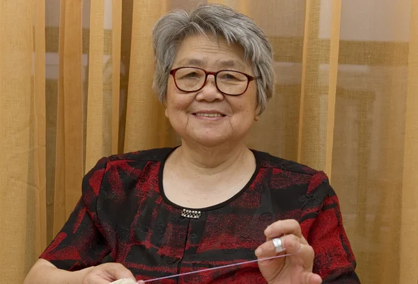Sewing grandma — Stock Photo, Image