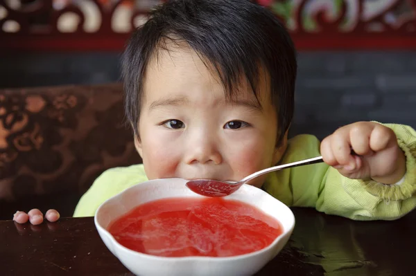 Cute baby drinking soup — Stock Photo, Image