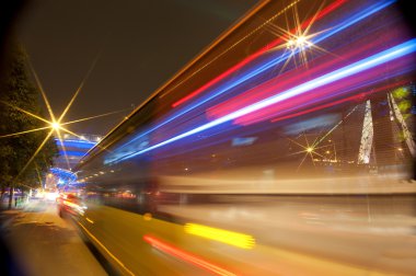 High-speed vehicles blurred trails on urban roads clipart