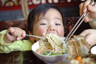 A cute baby is eating clipart