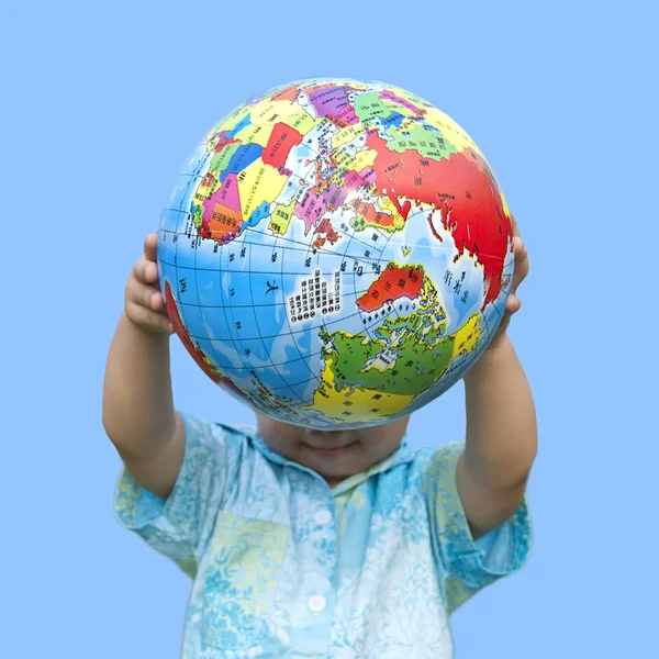 stock image Boy holding the earth model under blue sky