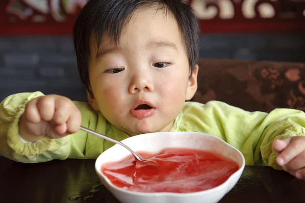 stock image A cute baby is drinking soup