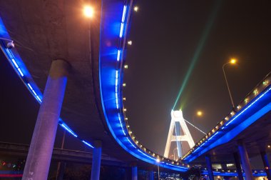 Bright lights under urban overpass clipart