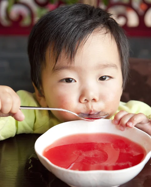 A cute baby to drink soup — Stock Photo, Image