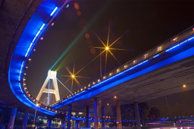 Bright lights under urban overpass clipart