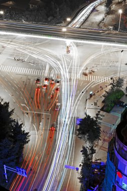 High speed traffic and blurred light trails under the overpass clipart