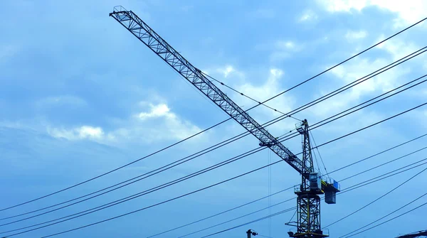 Stock image Tower crane under the blue sky in a work site