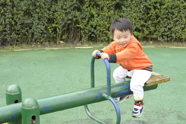 Baby spelen wip in een speelplaats voor kinderen — Stockfoto