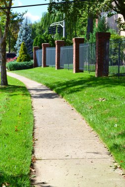 City Sidewalk Winds Through Neighborhood clipart