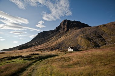 Old house in the mountains in Iceland clipart