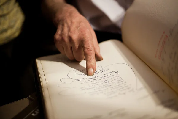 stock image Photo of man and his hands pointing old book