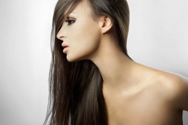Beautiful girl in profile, with long hair isolated on white background