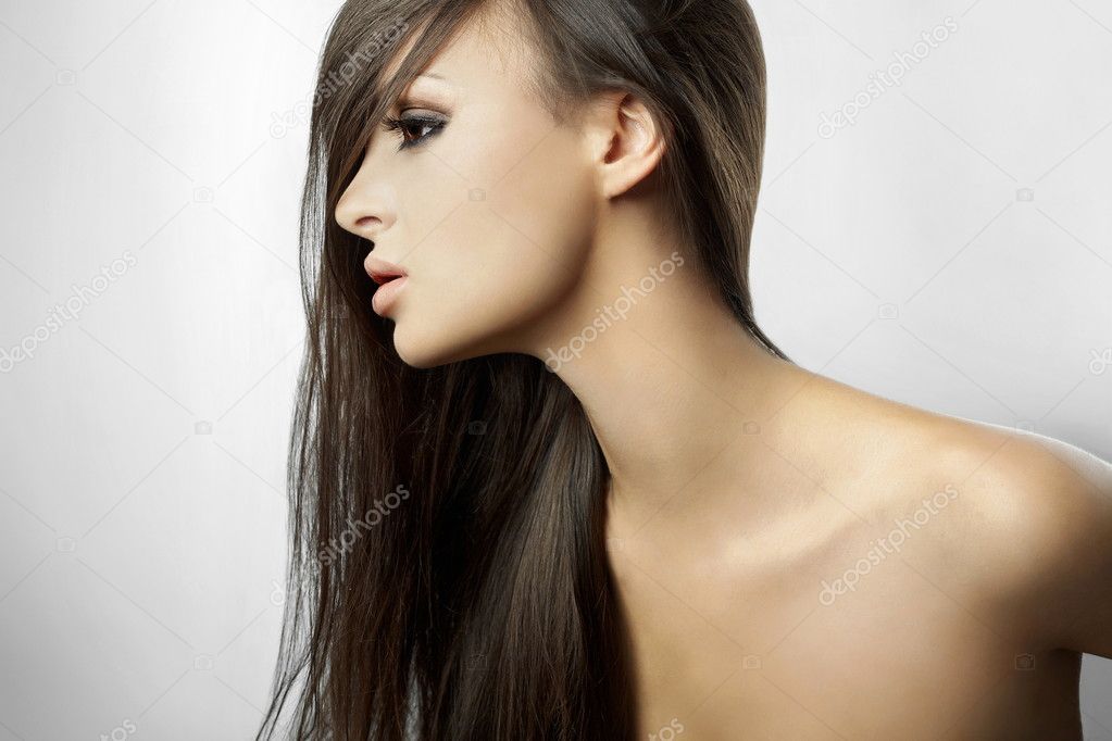 Beautiful girl in profile, with long hair isolated on white background