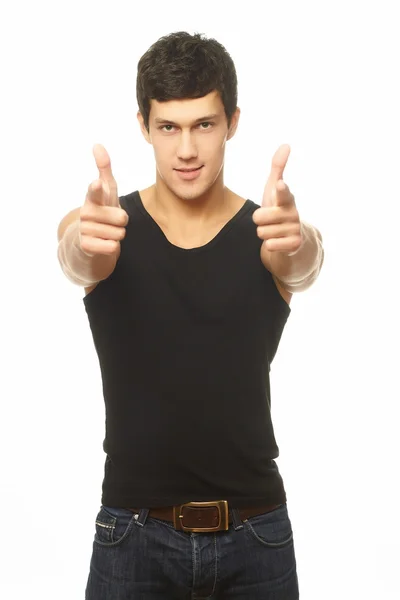 Successful muscled young man showing thumbs and smiling isolated — Stock Photo, Image